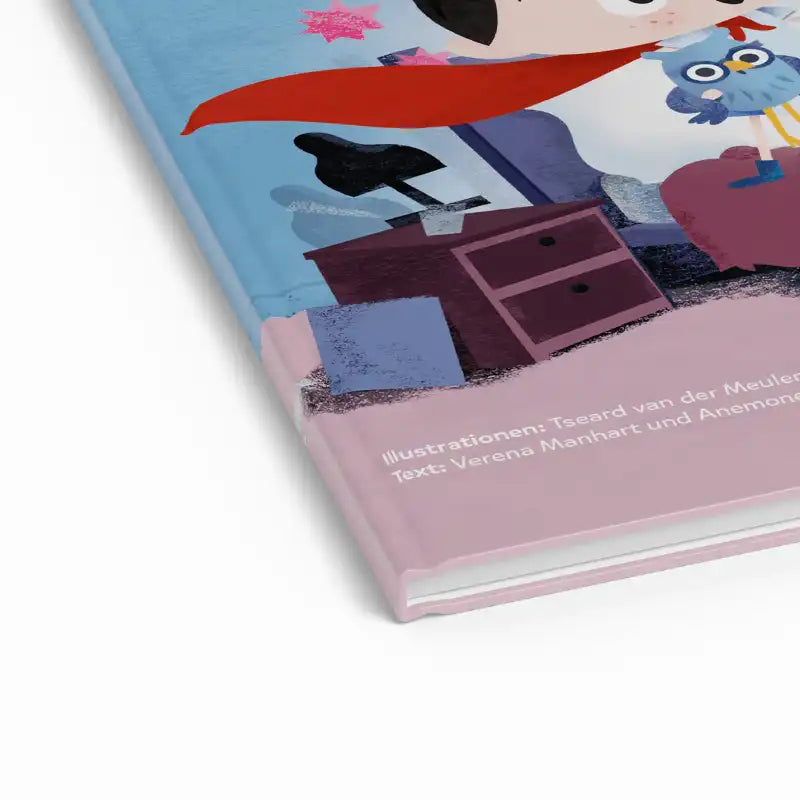 Nahaufnahme des Kinderbuchs Dein Mutmach-Buch zum Einschlafen mit Eule Molly Minimumm und einem Kind in einem roten Umhang an einem rosa Schreibtisch. Farbenfrohe Gute-Nacht-Geschichte mit inspirierenden Illustrationen.