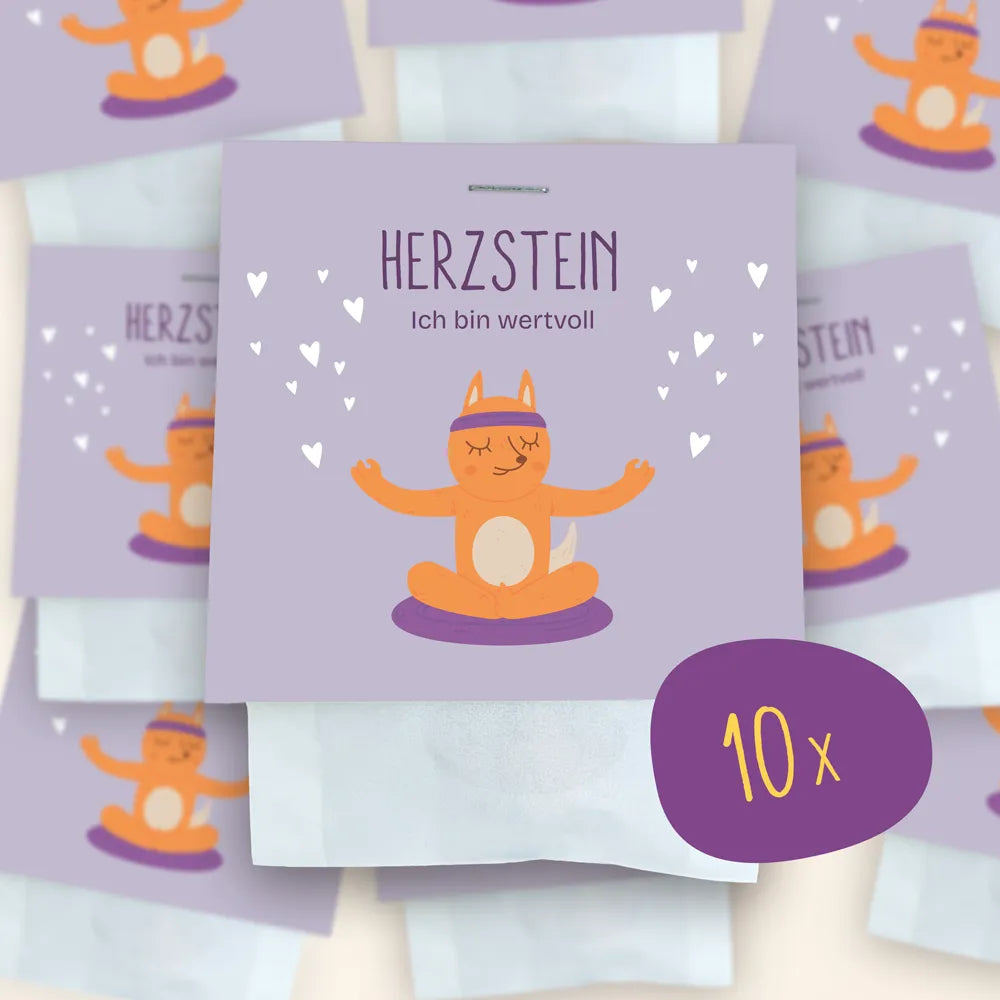10x Herzstein als Set: Im Mittelpunkt ist die Verpackung der Herzsteine zu sehen, im Hintergrund weitere verschwommen.