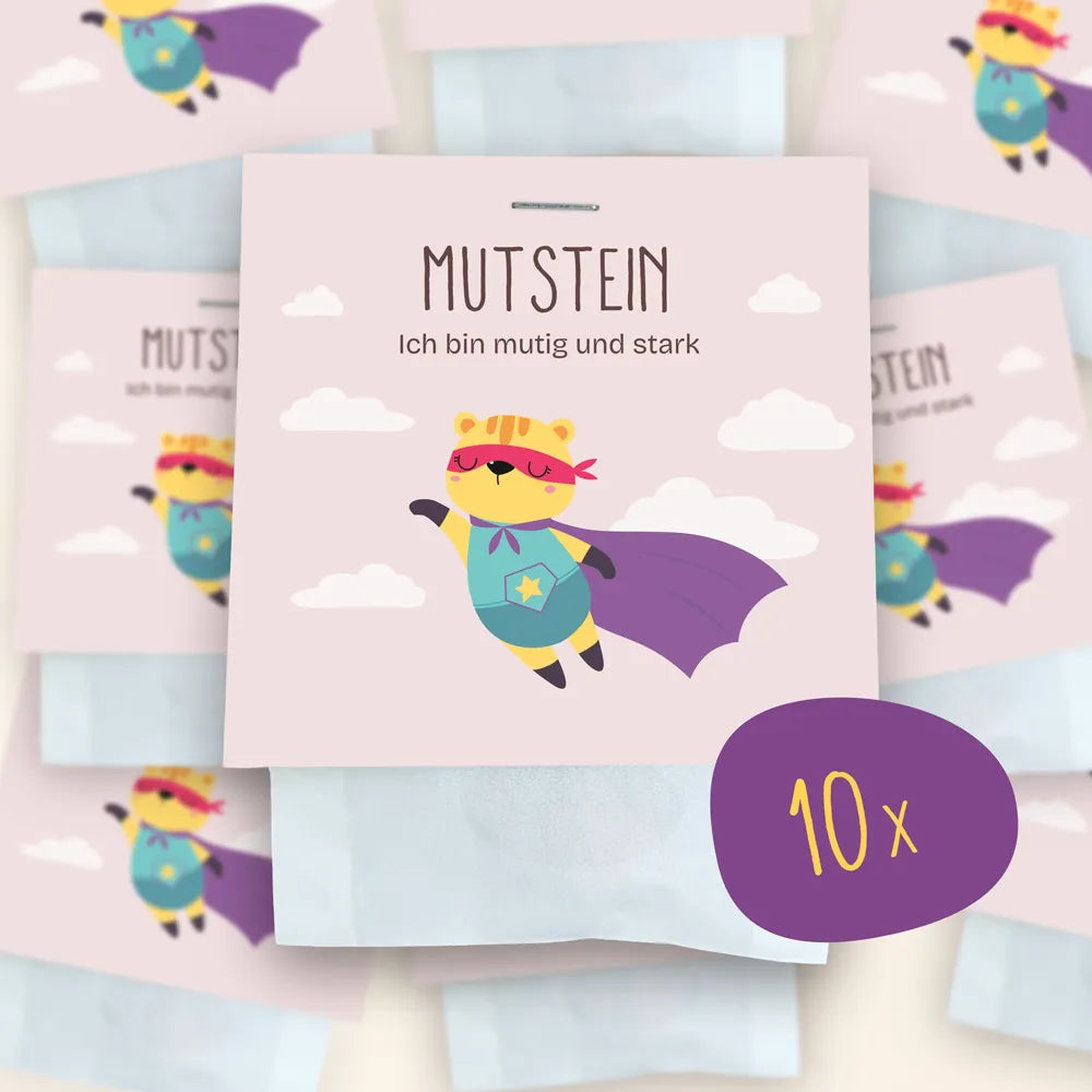 10x Mutstein als Set: Im Mittelpunkt ist die Verpackung der Mutsteine zu sehen, im Hintergrund weitere verschwommen.