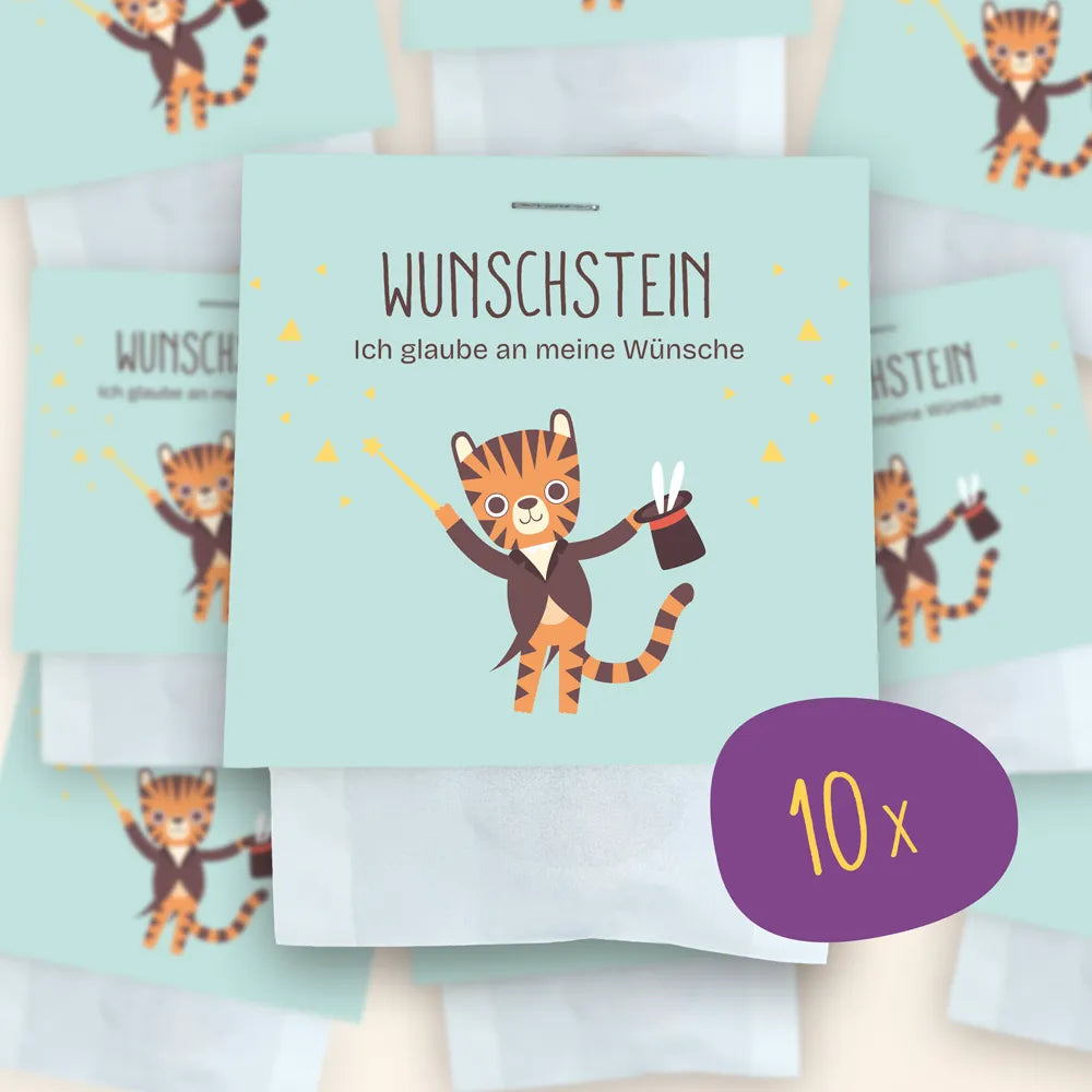 10x Wunschstein als Set: Im Mittelpunkt ist die Verpackung der Wunschsteine zu sehen, im Hintergrund weitere verschwommen.